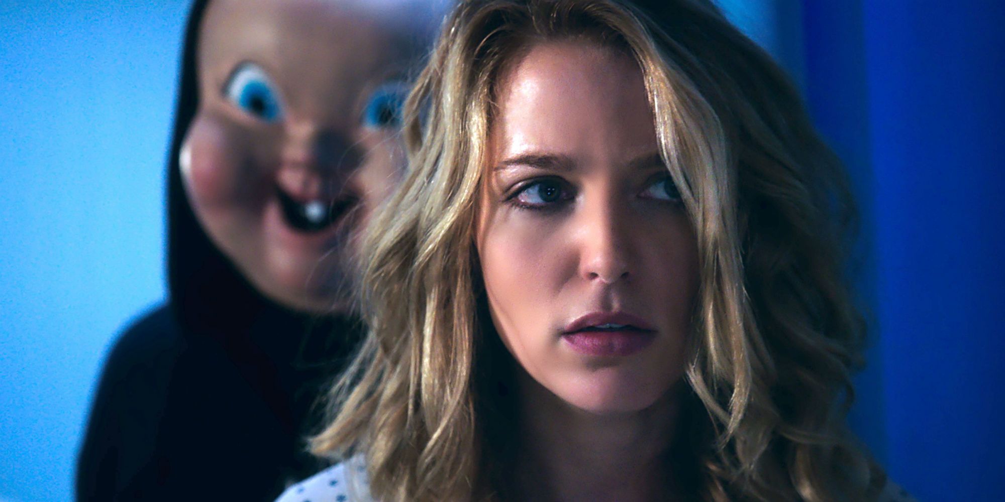 The Killer stands behind an unsuspecting Tree in Happy Death Day.