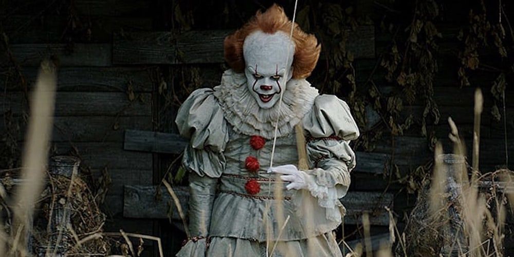 Pennywise stabding in a field in IT