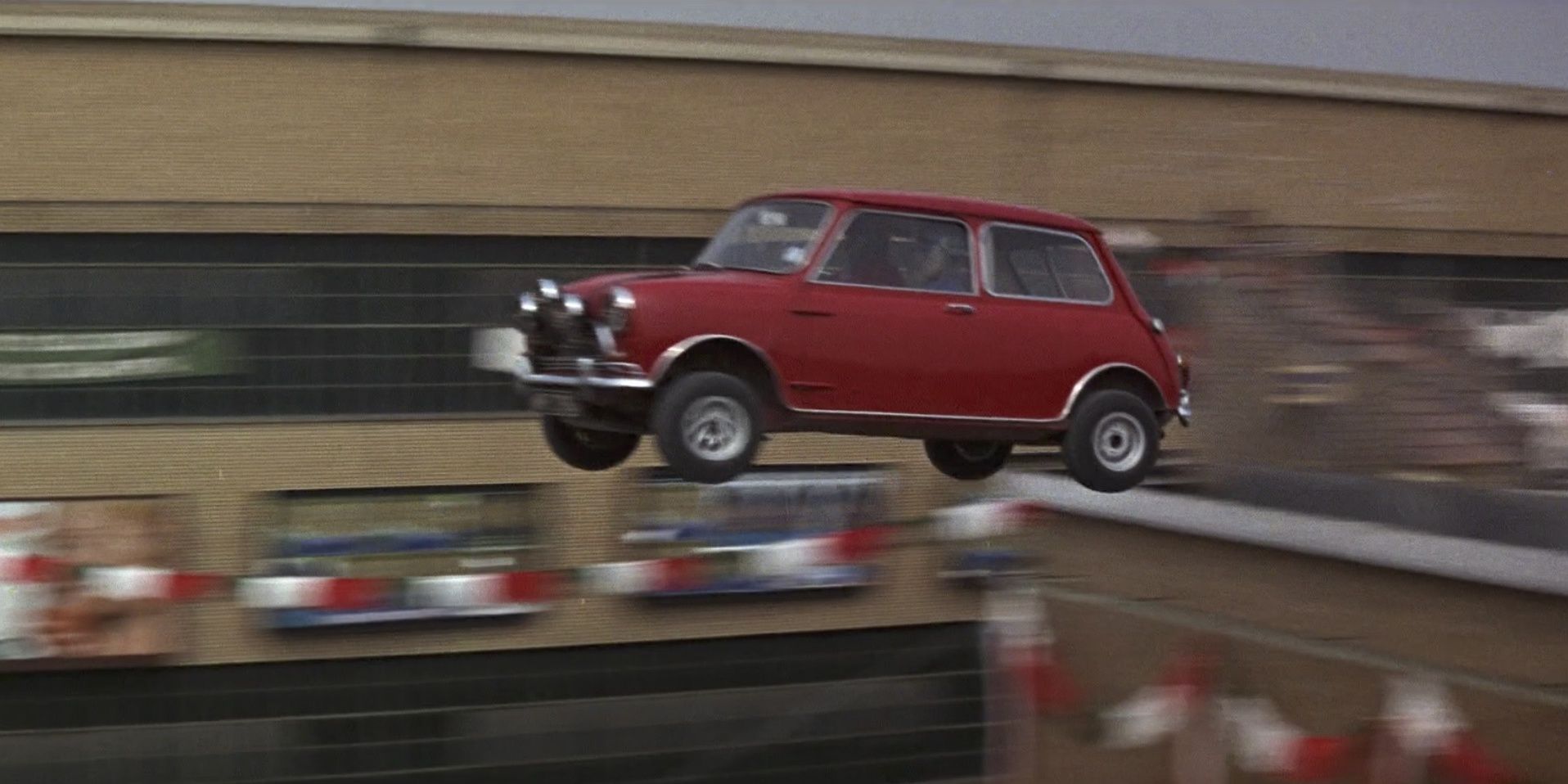 A Mini Cooper jumps over a ramp in The Italian Job