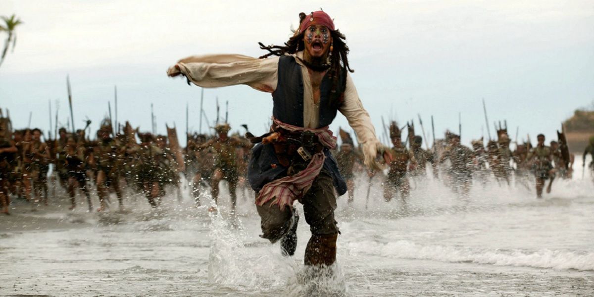 Jack Sparrow runs from a tribe in Pirates of the Caribbean: Dead Man's Chest