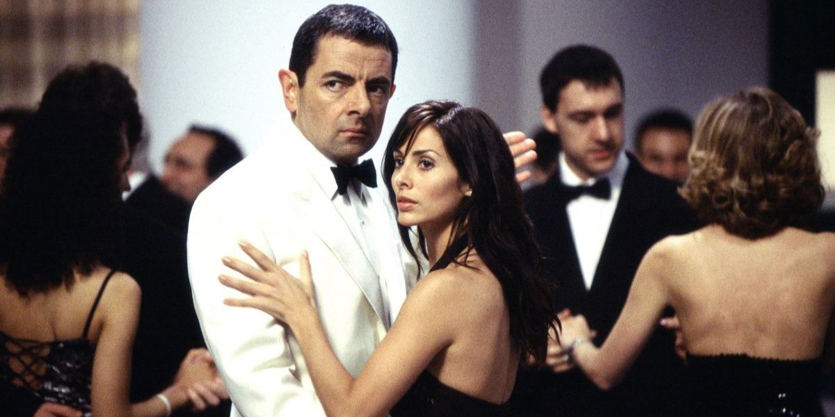 Johnny English dressed in a white tuxedo at a party in Johnny English