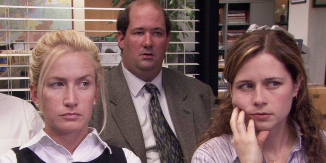 Kevin, Pam, and Angela sitting in a meeting on The Office.