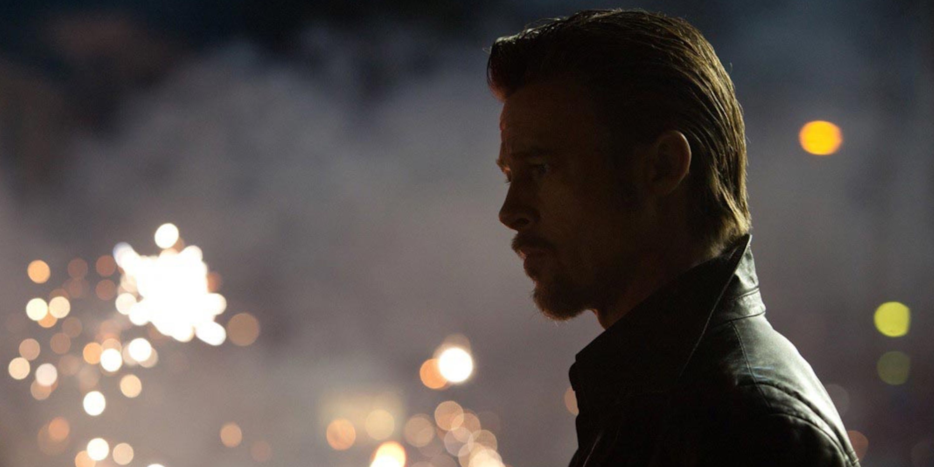 Brad Pitt with fireworks in the background in Killing Them Softly