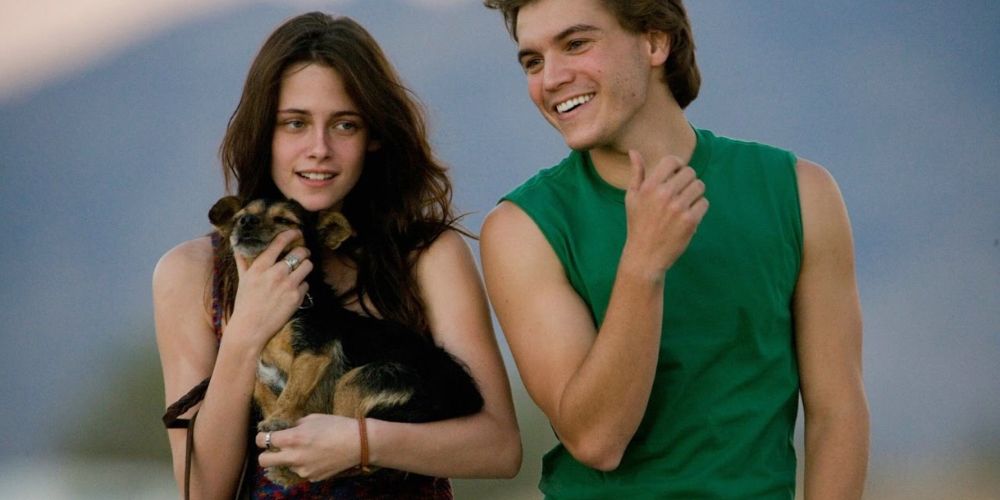 Tracy, holding a dog, and Chris walking together in Into the Wild