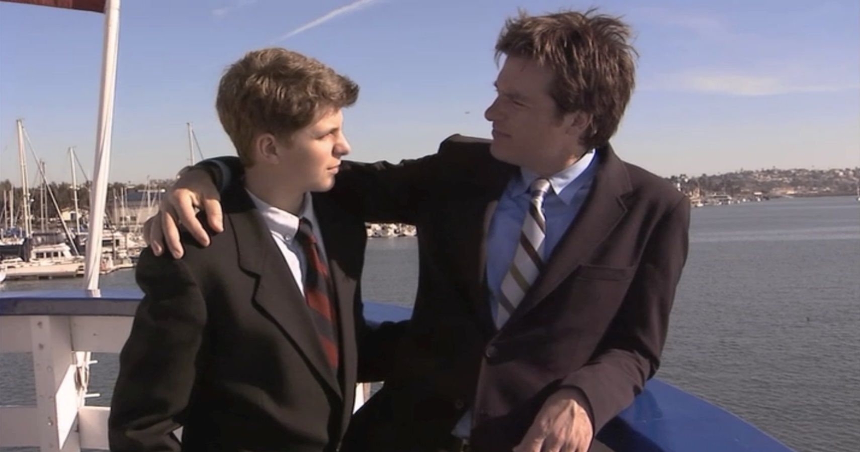 Michael and George Michael talking while on a boat standing in a boat in Arrested Development