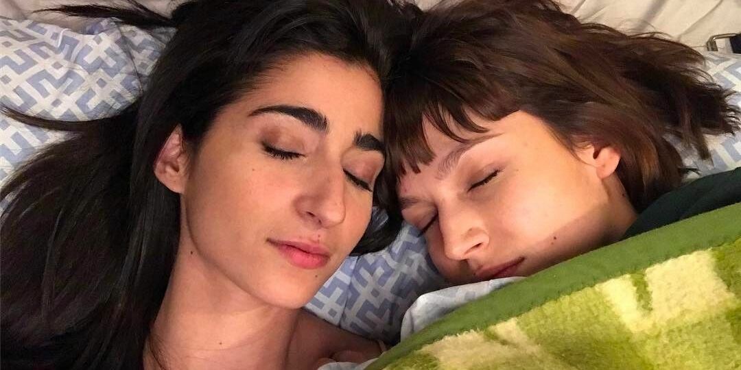 A photo of Nairobi and Tokyo laying next to each other with their eyes closed in the show Money Heist.