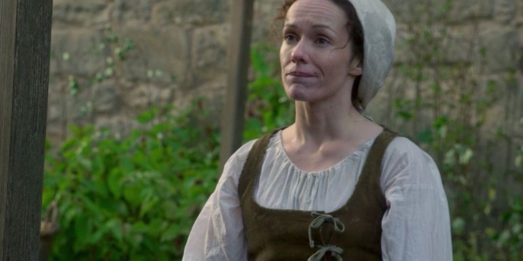 Mary McNabb in apron looking pensive in Outlander
