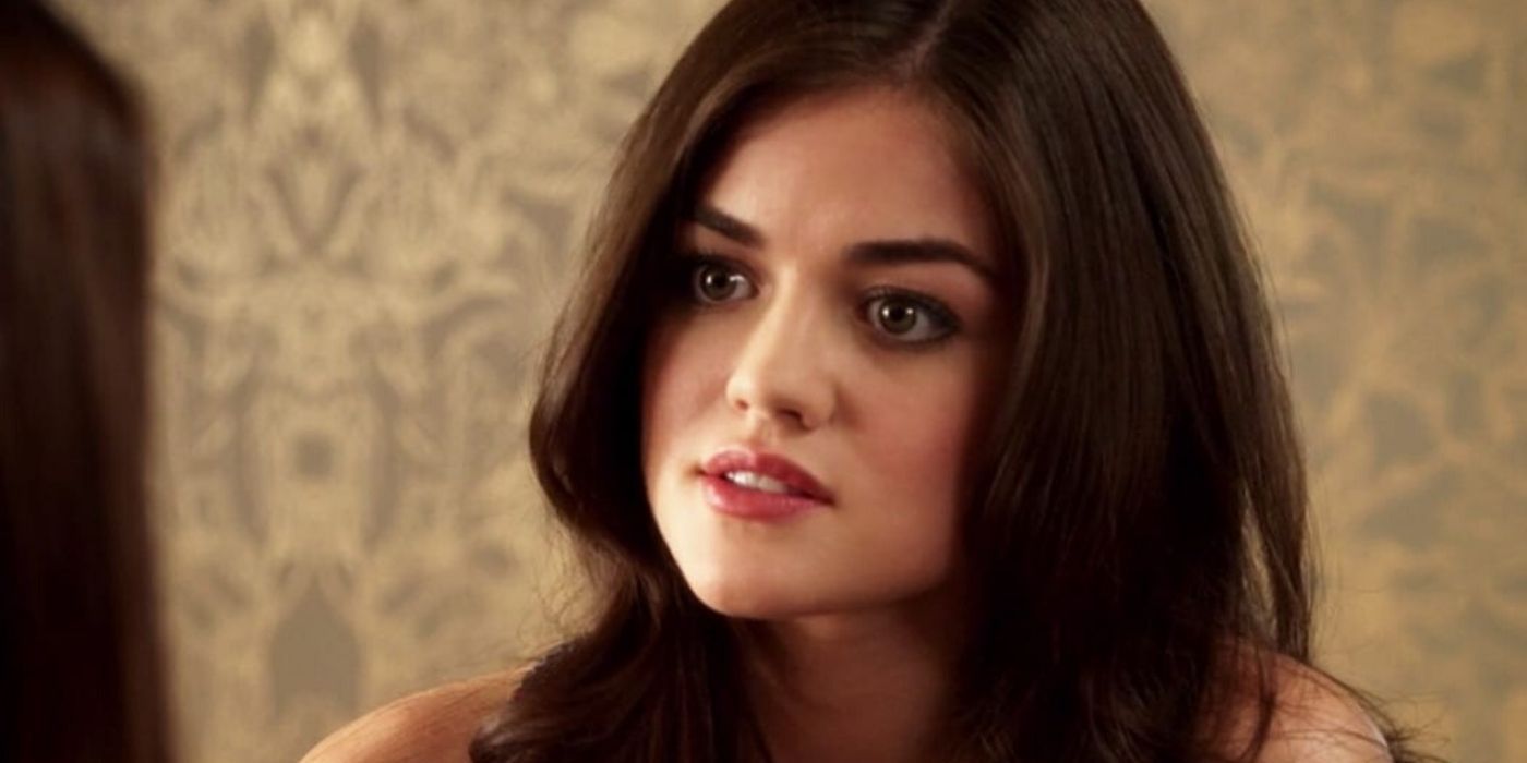 Aria listens intently during a conversation in Pretty Little Liars