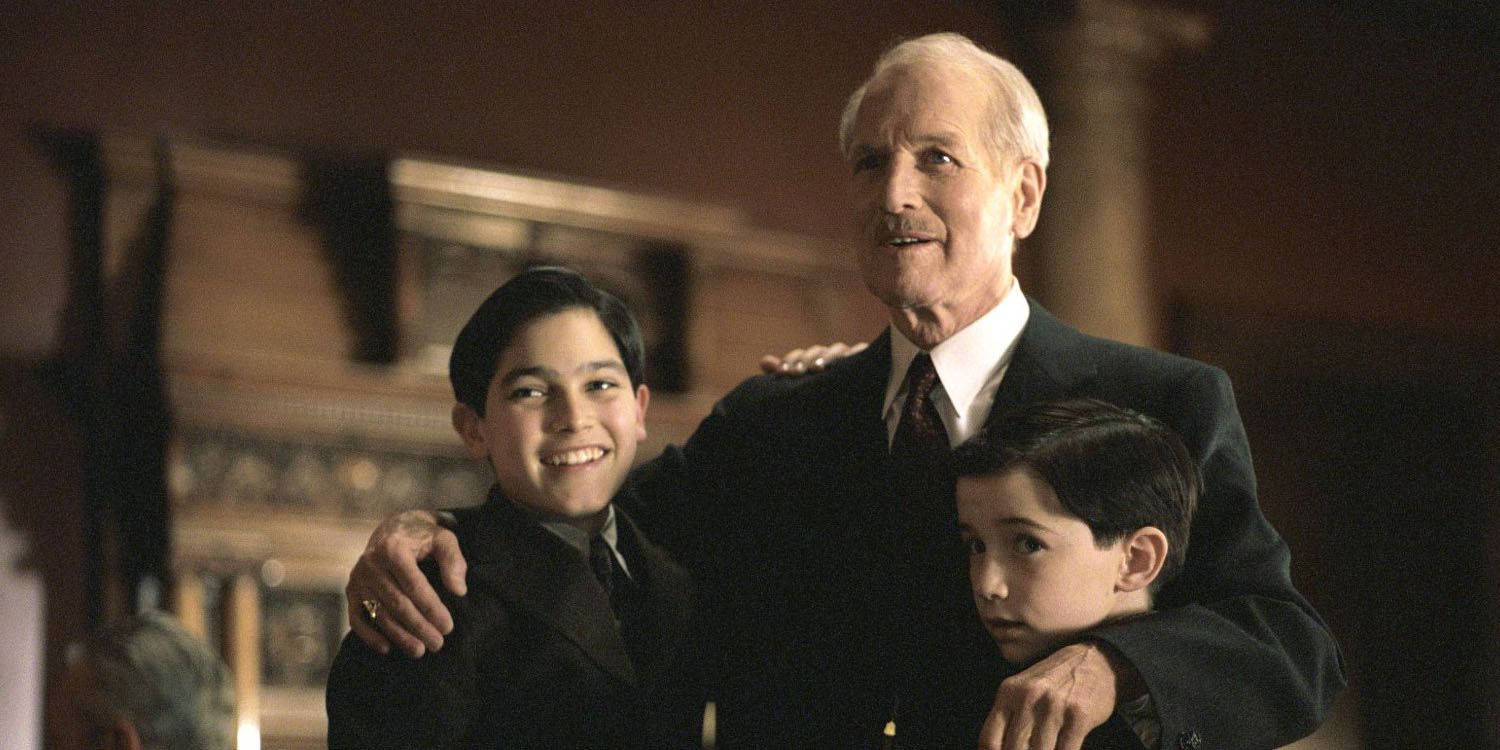 An image of Tyler Hoechlin hugging Paul Newman in Road to Perdition