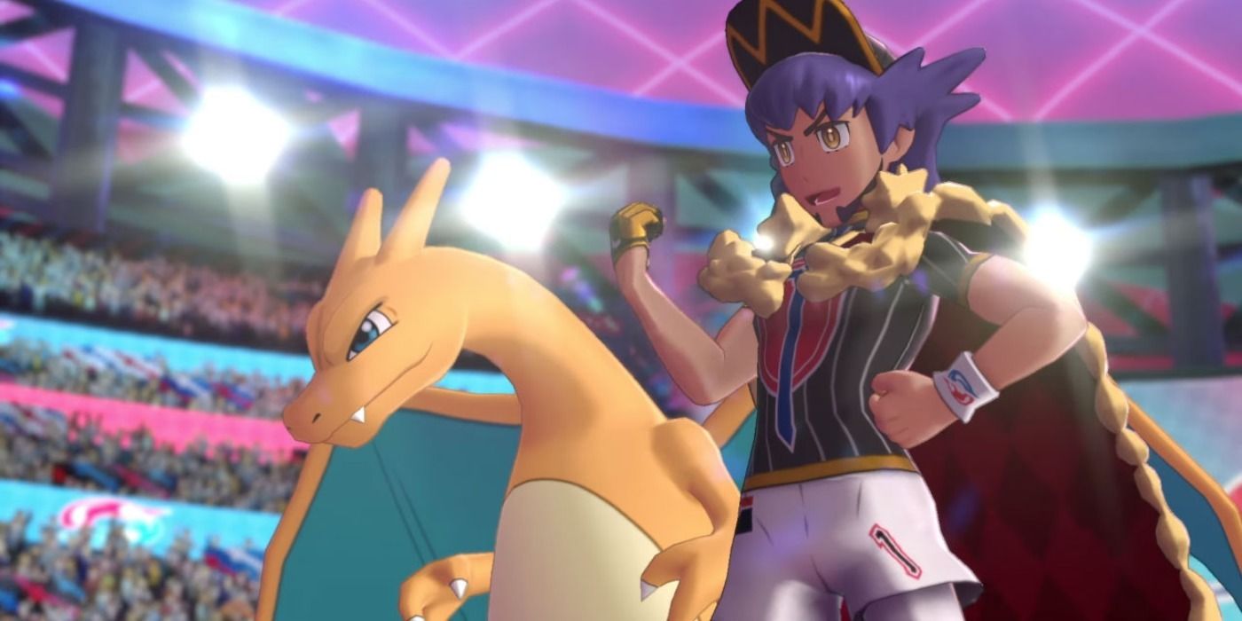 Leon and Charizard standing proudly in a stadium in Pokémon Sword & Shield.