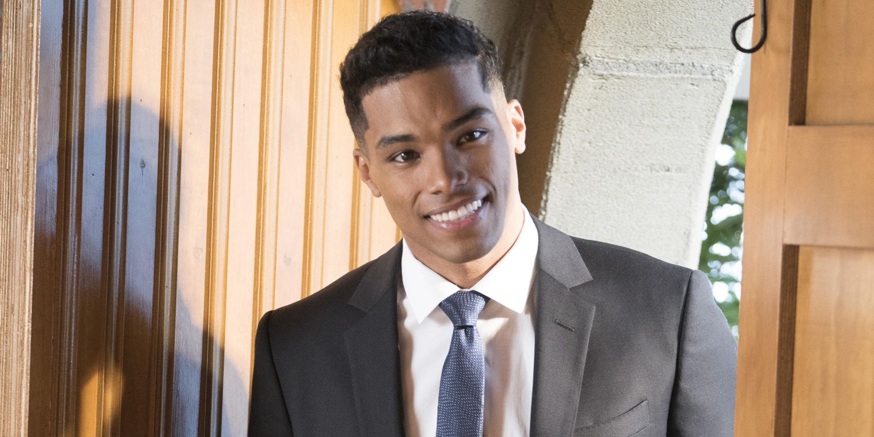Rome Flynn as Gabriel Maddox smiling at the door in How to Get Away with Murder