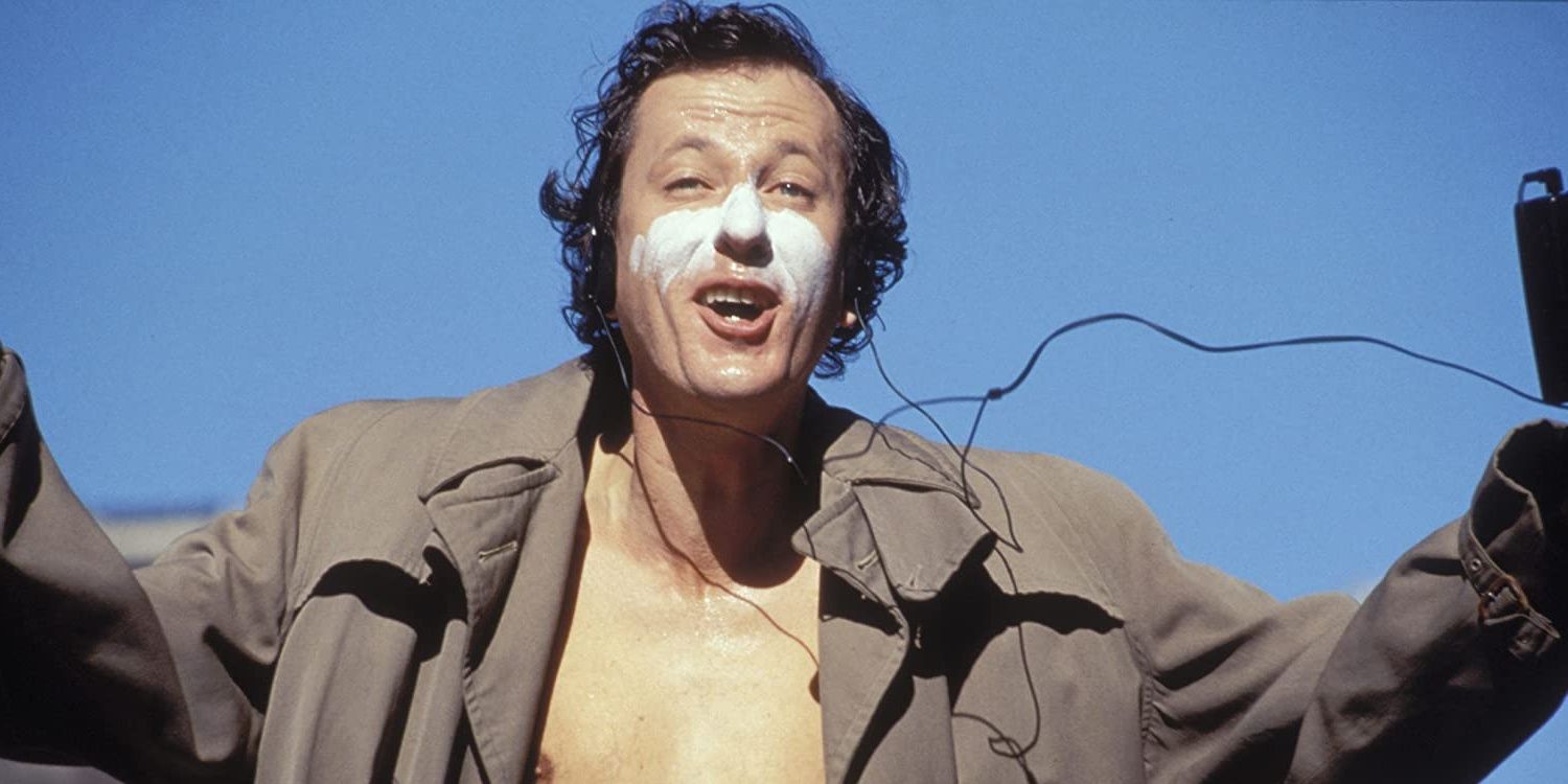 Geoffrey Rush in Shine with white paint on his face and arms out.