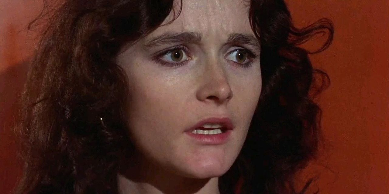 Margot Kidder looking anxious against a red background in Sisters.
