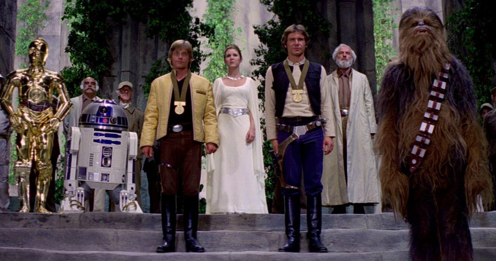 Luke, Han, Leia, Chewbacca, C-3PO,, and R2-D2 at the medal ceremony on Yavin IV in A New Hope