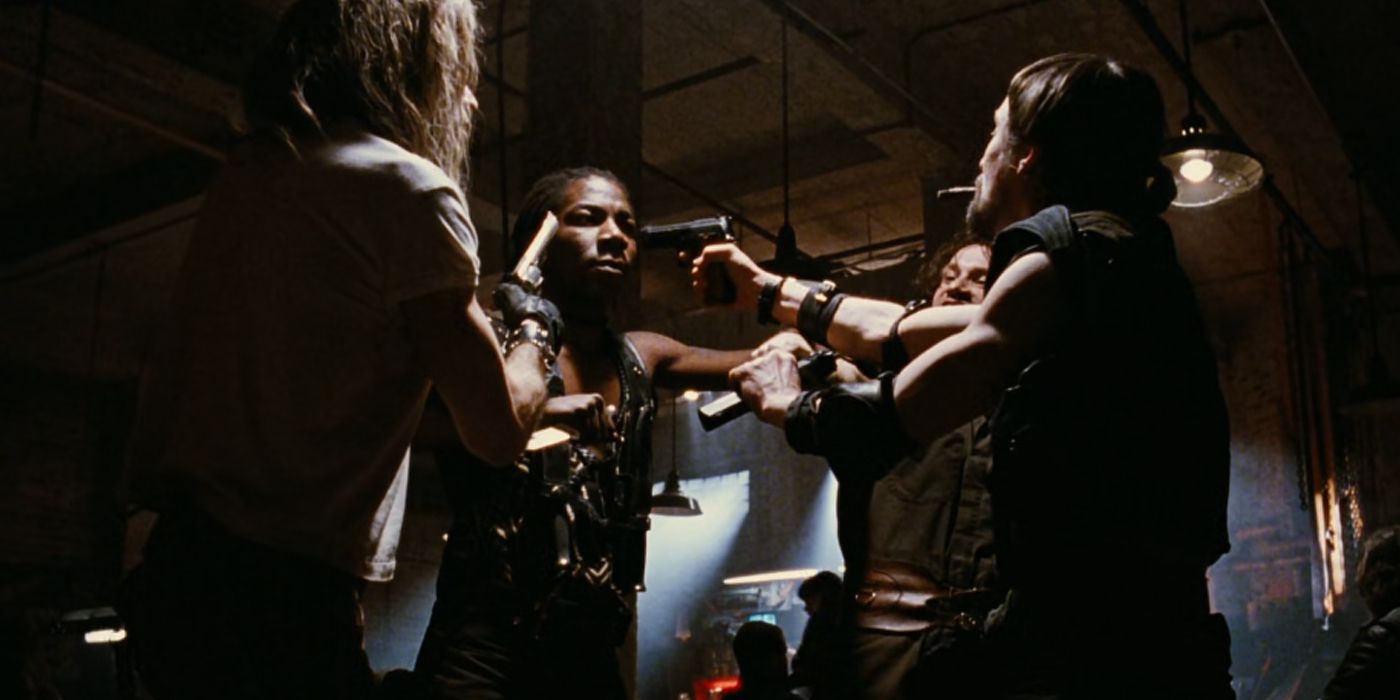 The gang all pointing guns at each other in The Crow.