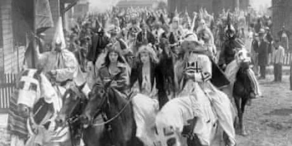A group of people riding horses in The Birth Of A Nation.