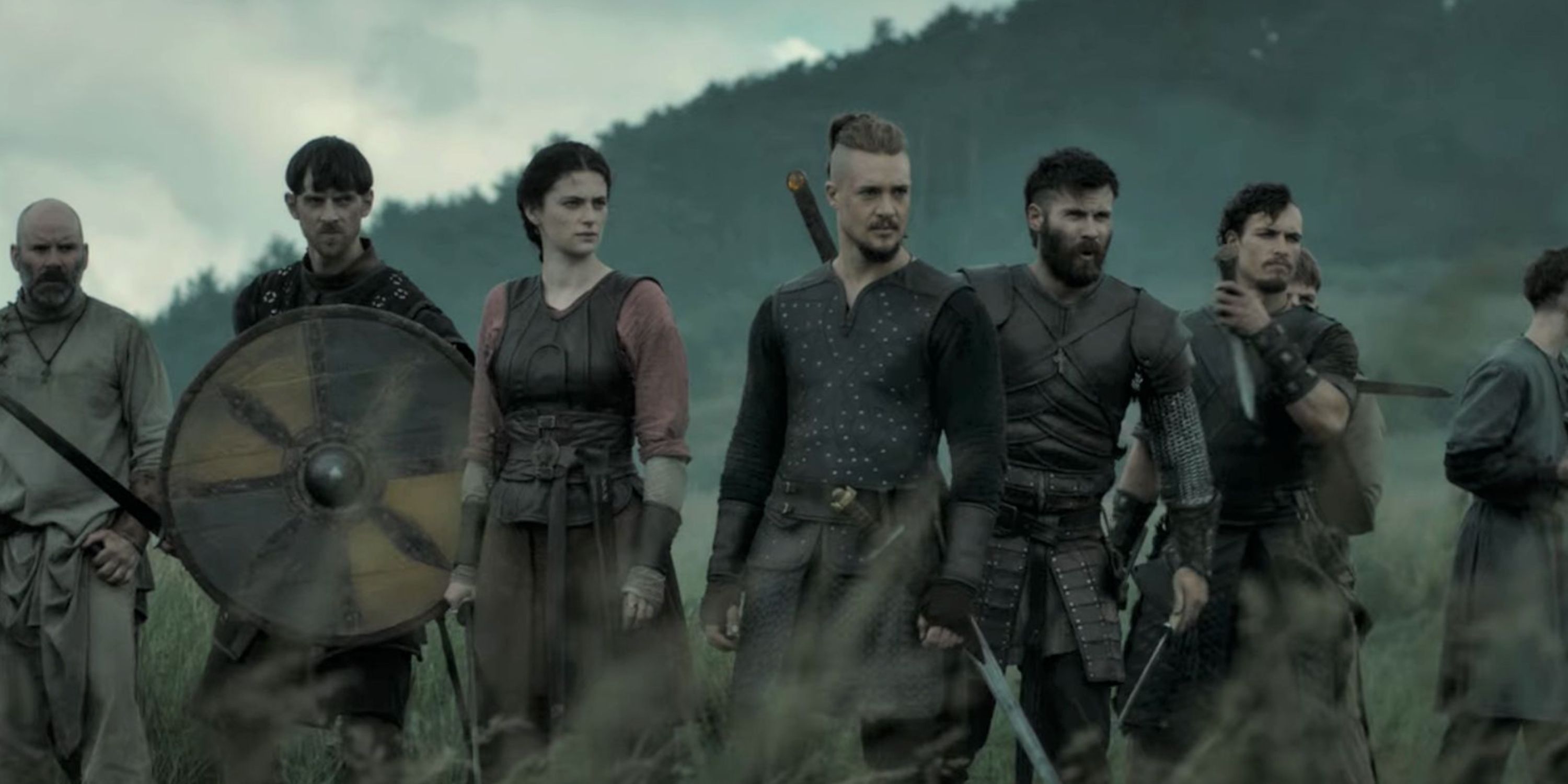 Uhtred standing with Finan and Aethelflaed in The Last Kingdom.