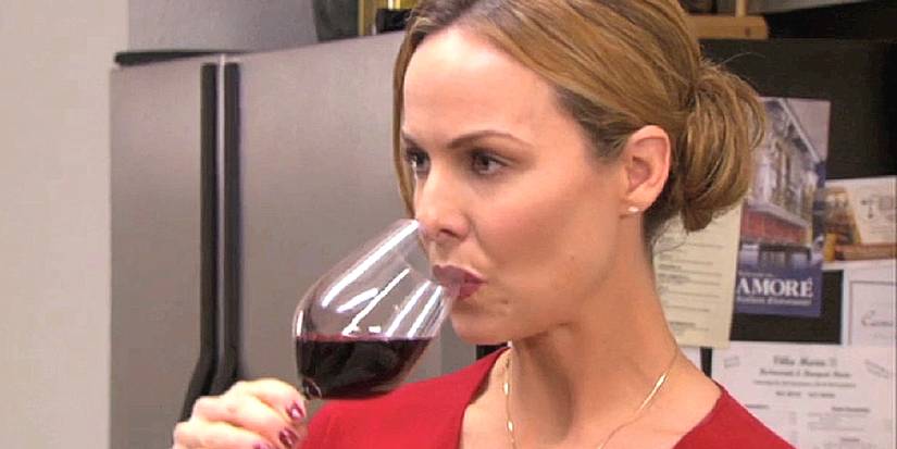 Jan (Melora Hardin) aggressively takes a sip of wine in The Office episode Dinner Party
