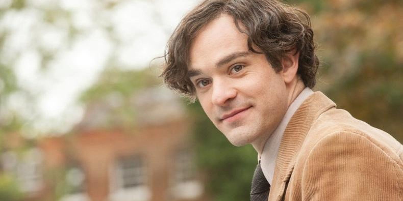 Charlie Cox smiling in The Theory of Everything