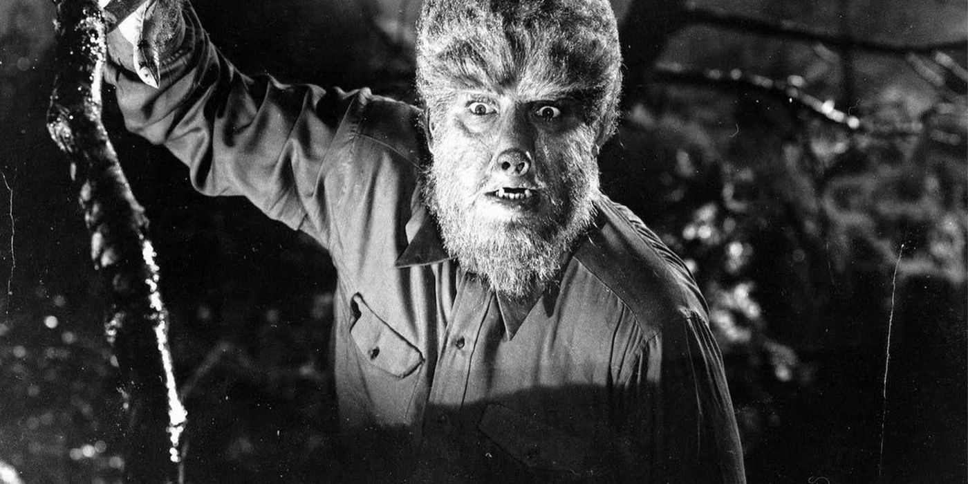 The Wolfman looks on from among trees.