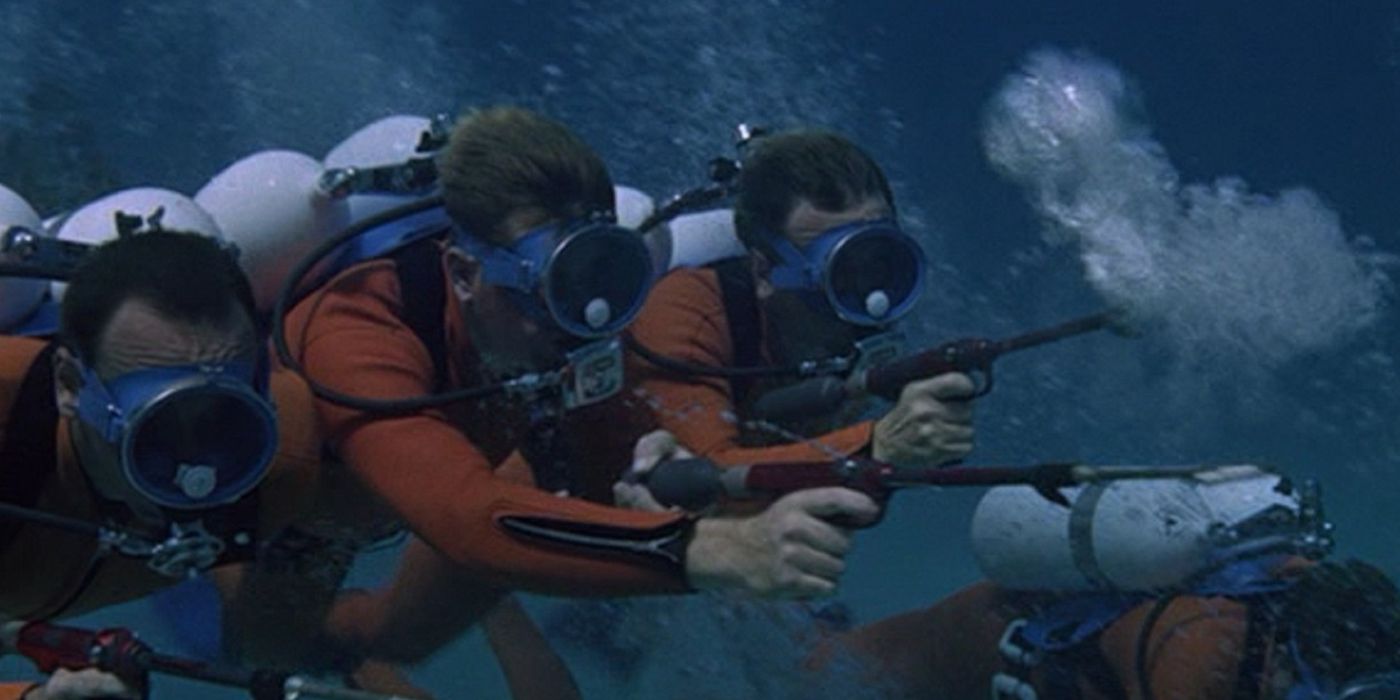 Four masked divers are under water and pointing guns in Thunderball.