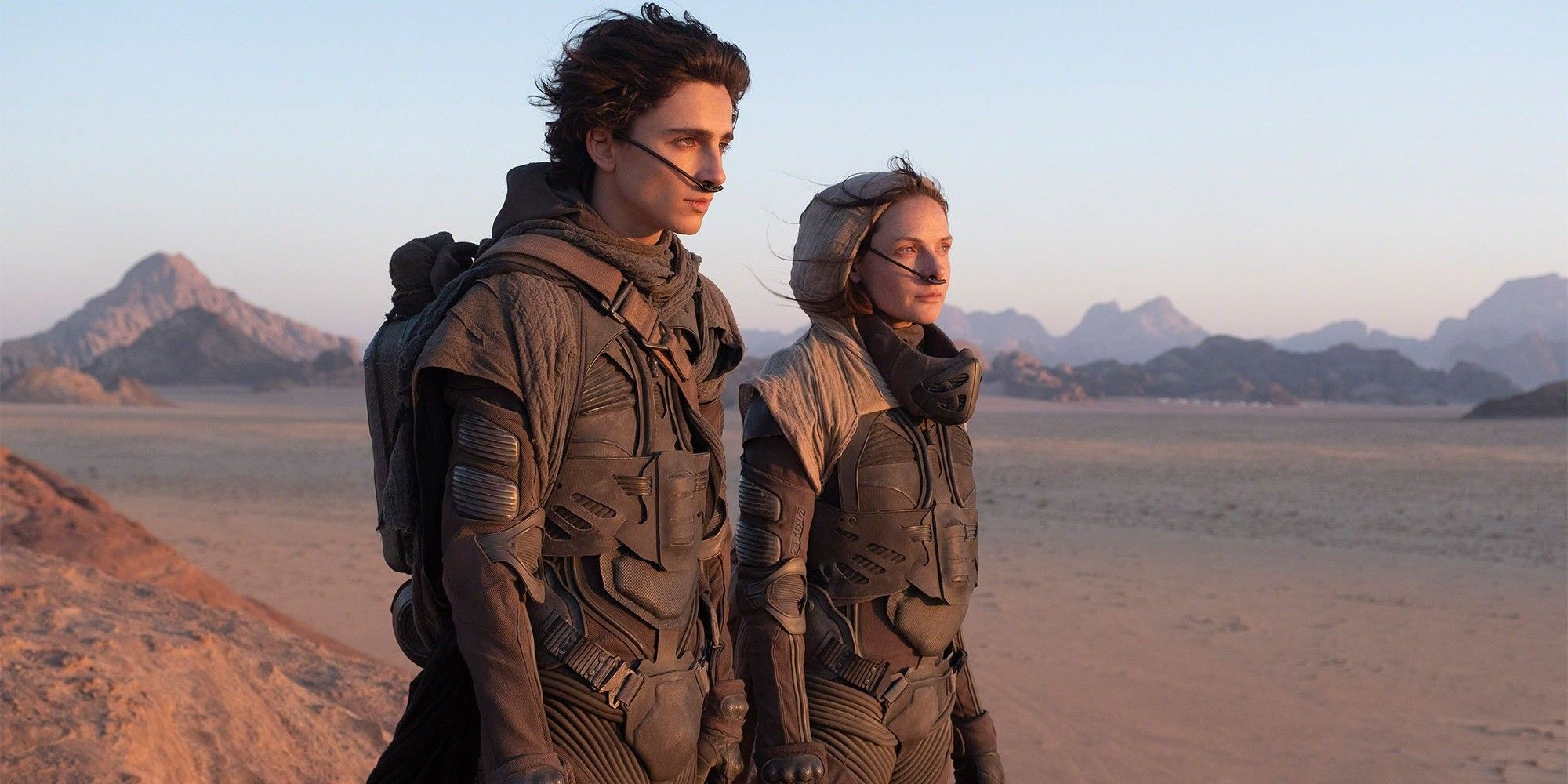 Paul and Lady Jessica looking out at the desert in Dune (2021).