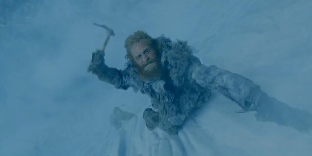 Tormund climbing the wall with an ice pick in hand