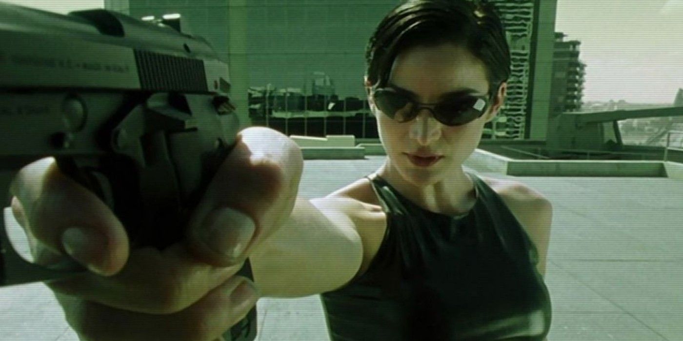 Trinity shooting her gun on a rooftop in The Matrix