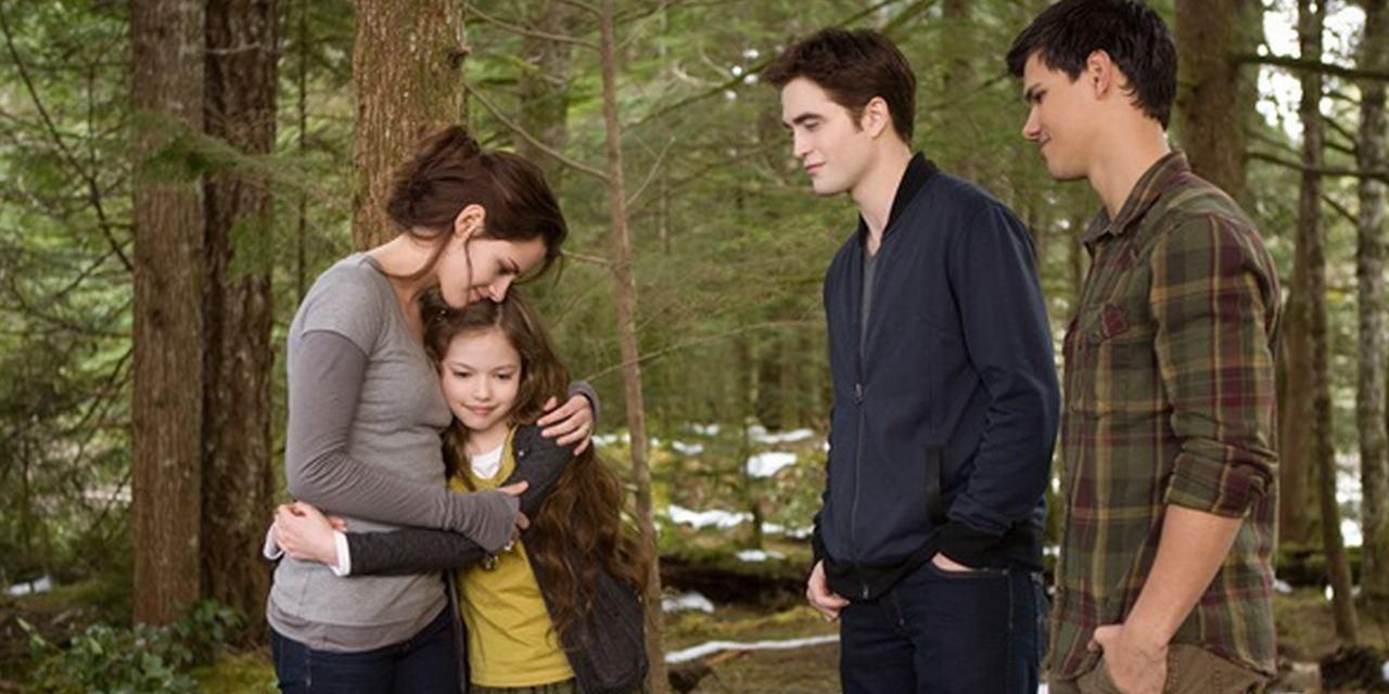 Bella hugs renesmee, while Edward and Jacob watch