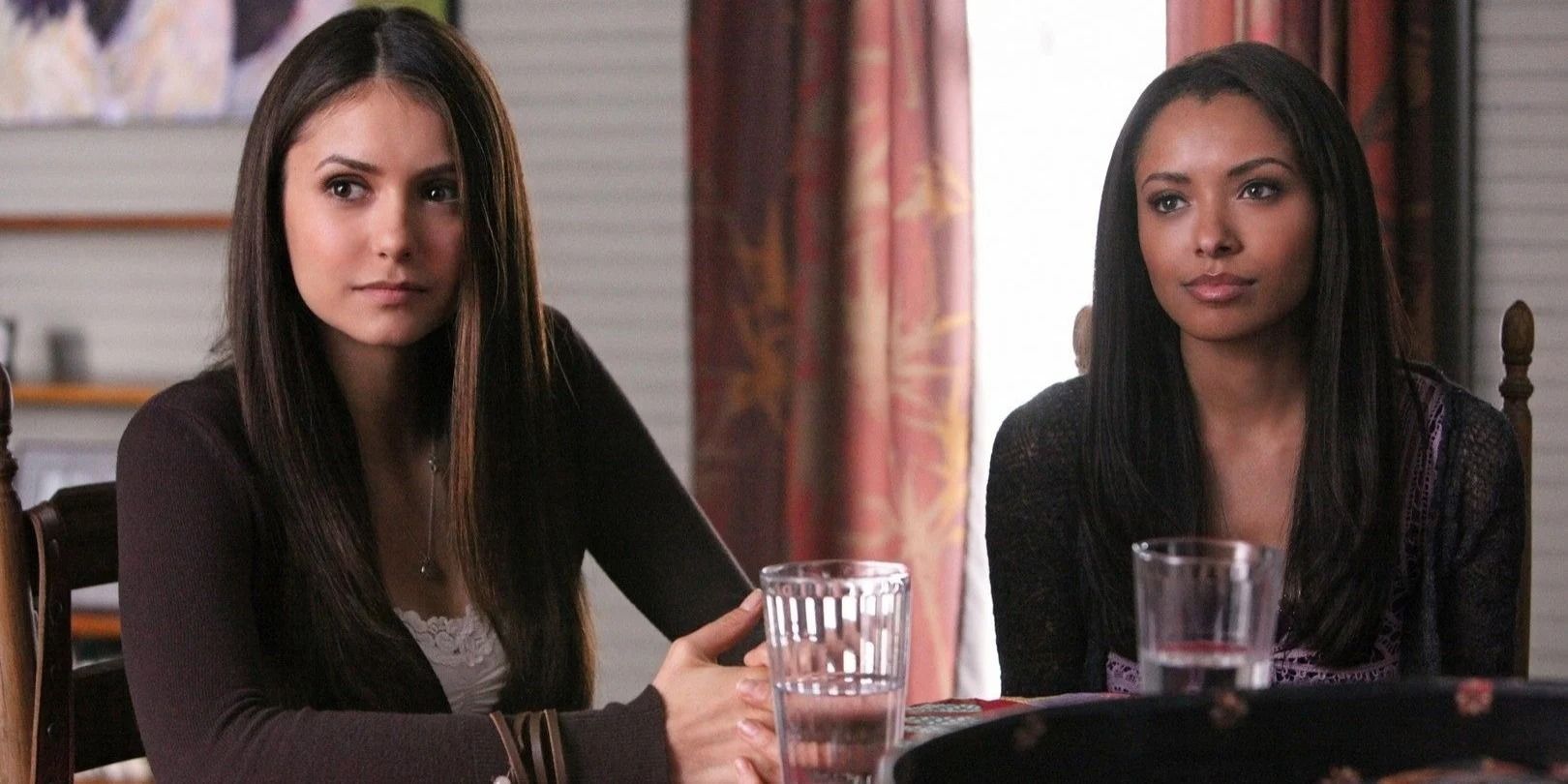 Bonnie and Elena sitting at kitchen table in The Vampire Diaries