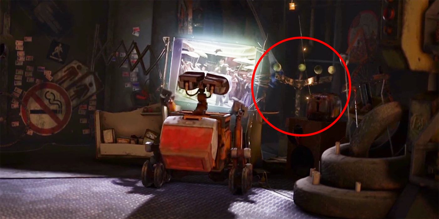 Wall-E in his home watching a video.