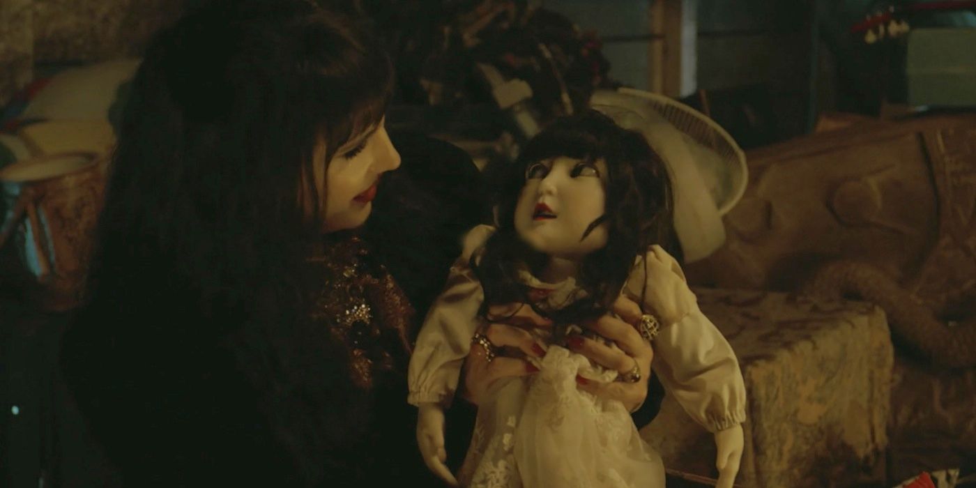 Nadja smiling at her doll in What We Do In The Shadows.