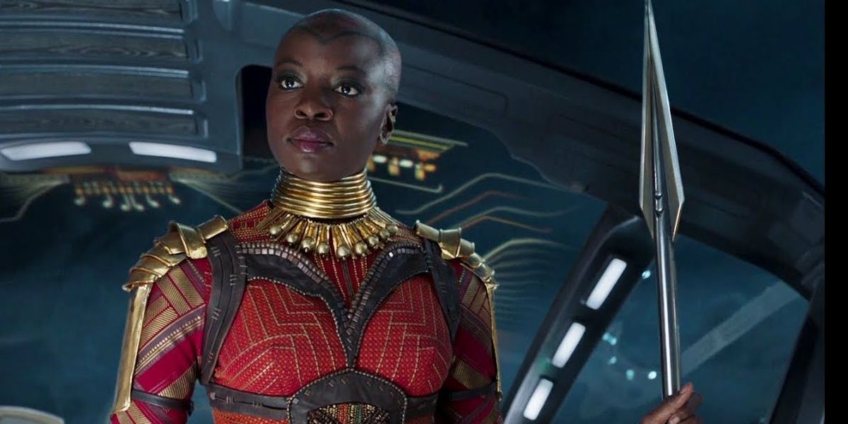 Okoye holding her spear on a Wakandan ship in Black Panther