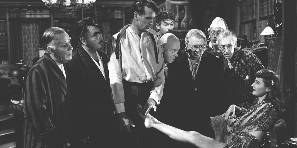 eight men stare at Barabara Stanwyck in Ball of Fire