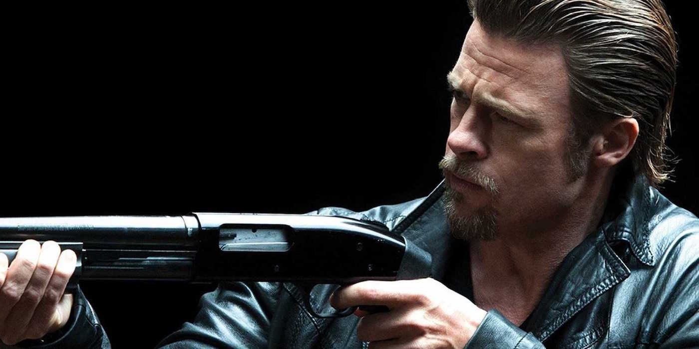 Brad Pitt holding a gun as Jackie Cogan in Killing Them Softly