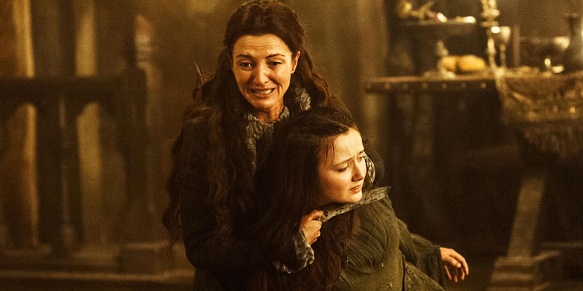 Catelyn Stark holds a knife to Walder Frey's wife in Game of Thrones