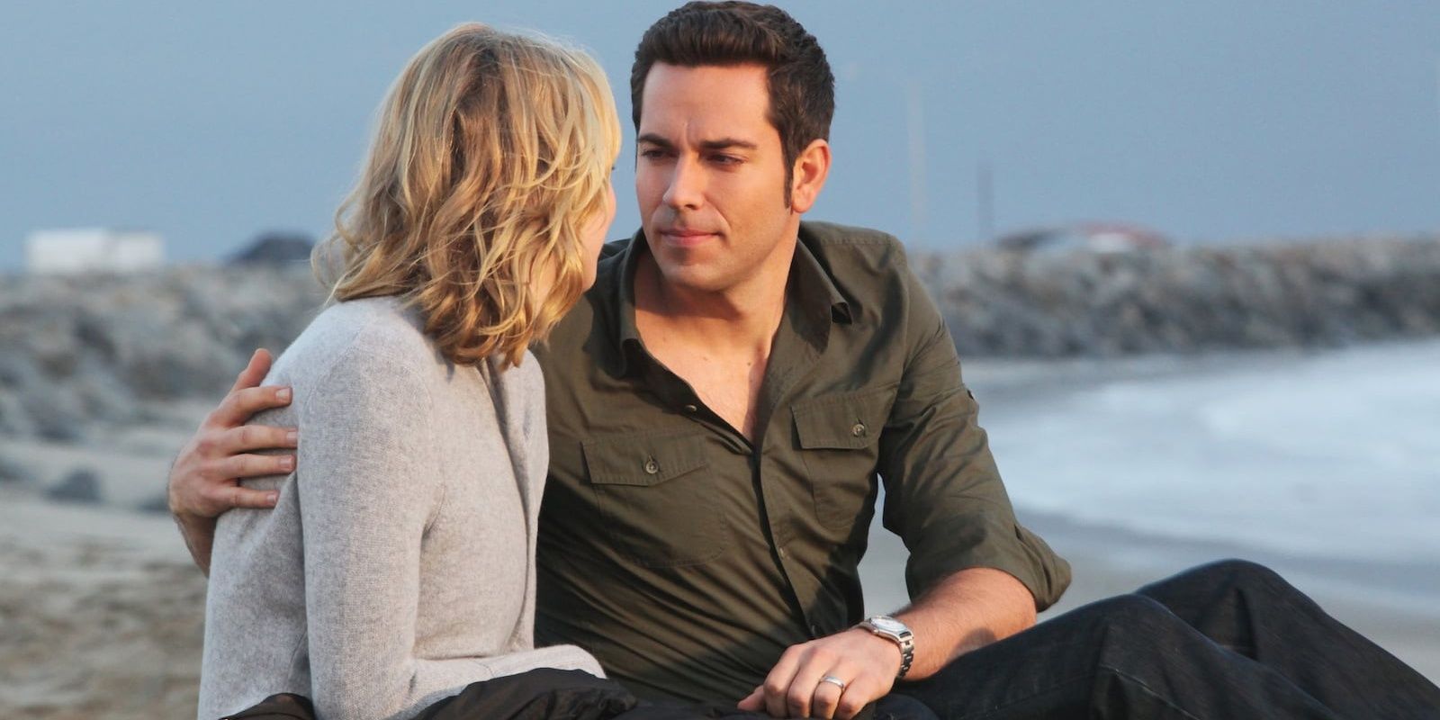 Chuck and Sarah sit on the beach together