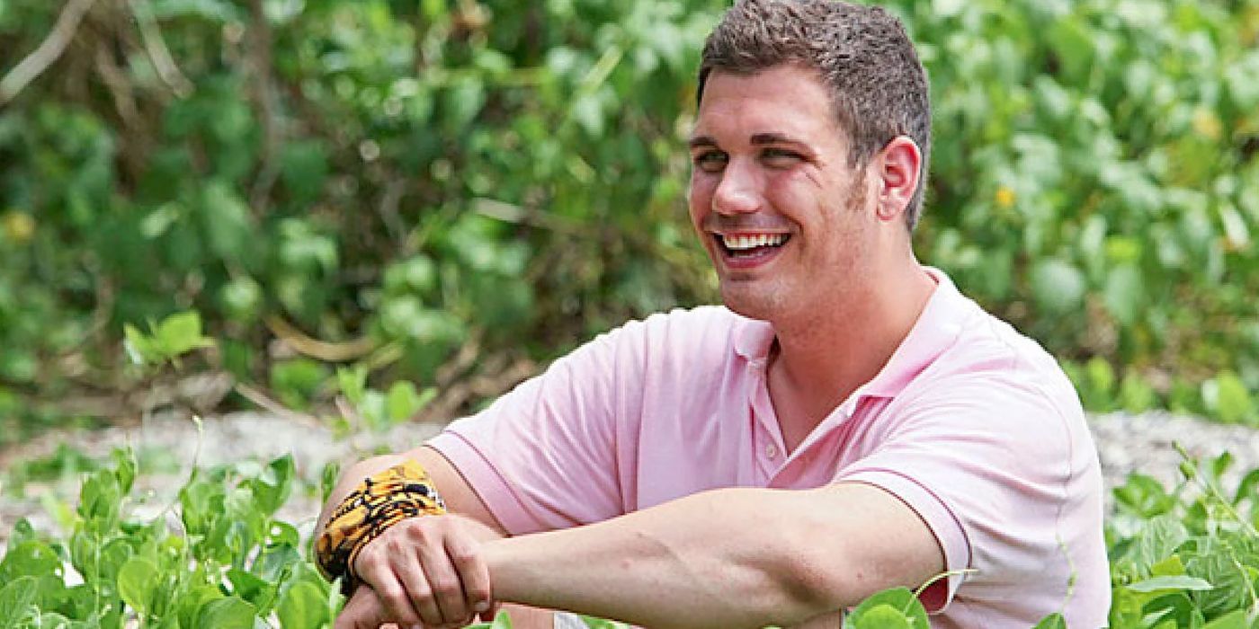 Colton Cumbie sitting on the ground smiling in on Survivor