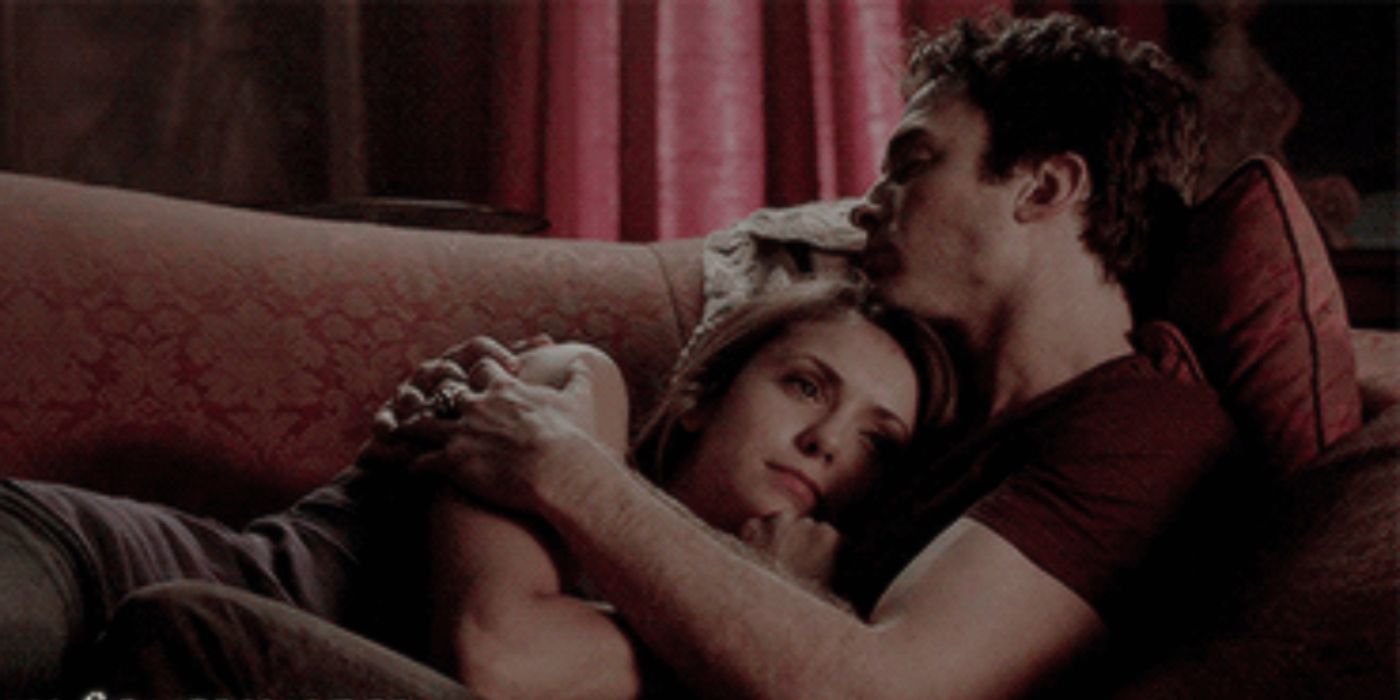 Damon (Ian Somerhalder) and Elena (Nina Dobrev) from the Vampire Diaries cuddling on the couch