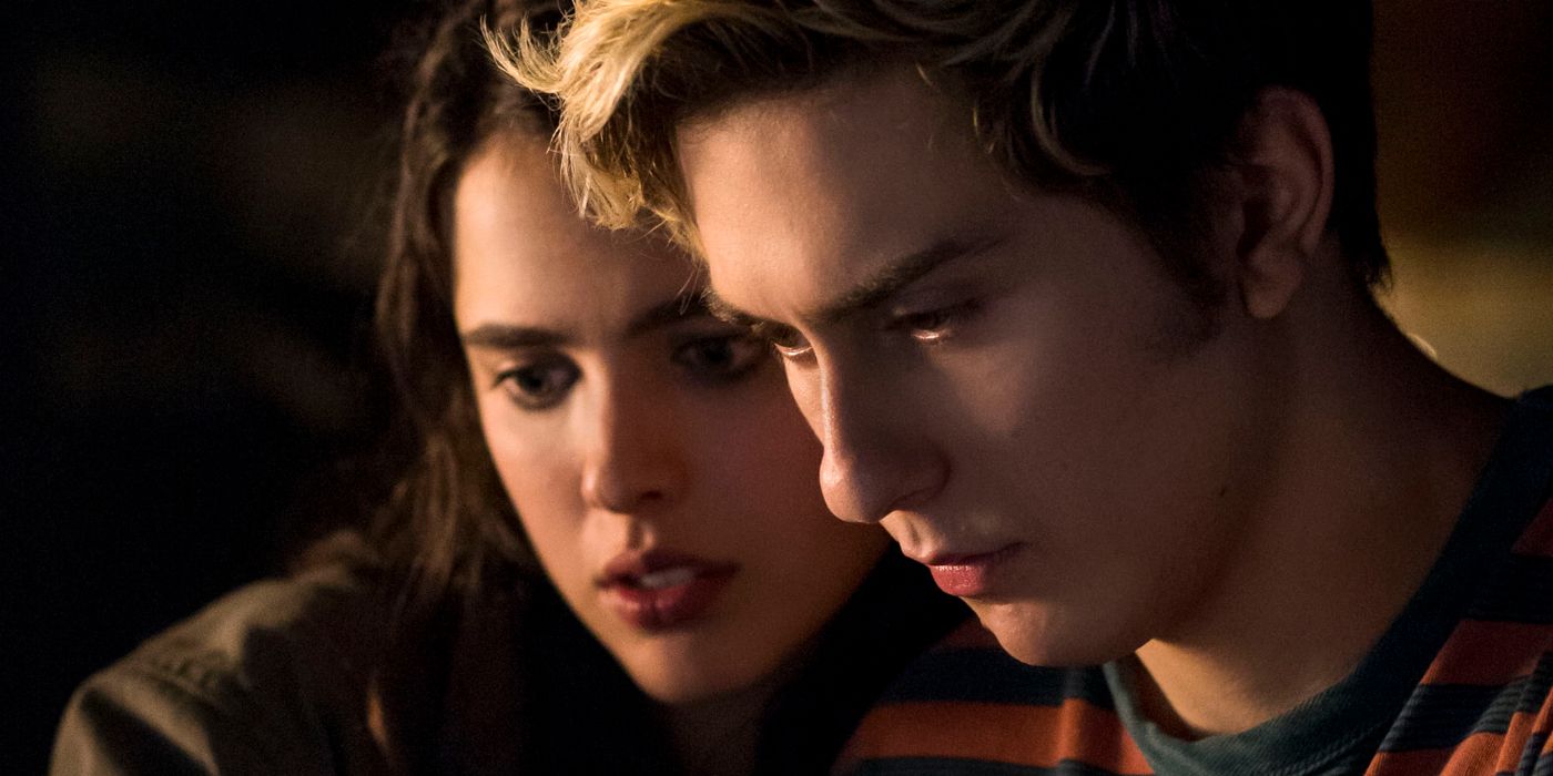 Nat Wolff as Light and Margaret Qualley as Mia Sutton looking down at something in the movie Death Note