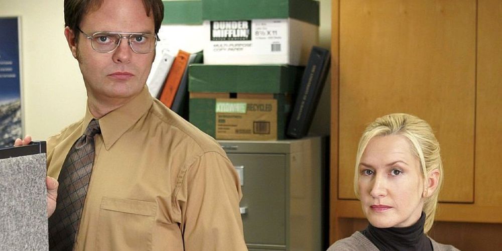 Dwight and Angela standing together on The Office.