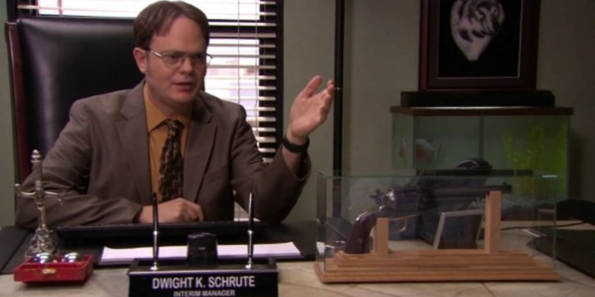 Dwight sits in the manager desk in The Office