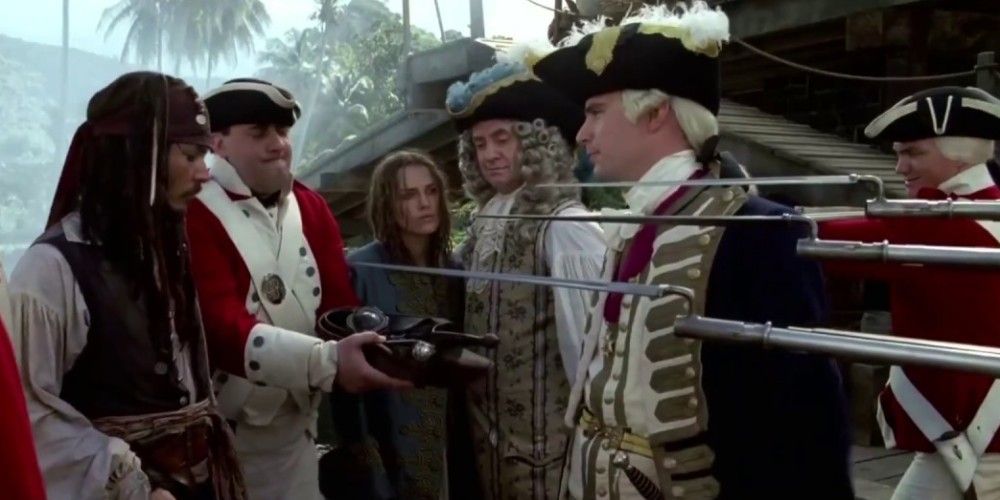 British soldiers point their weapons at Jack Sparrow in Pirates of the Caribbean: Curse of the Black Pearl
