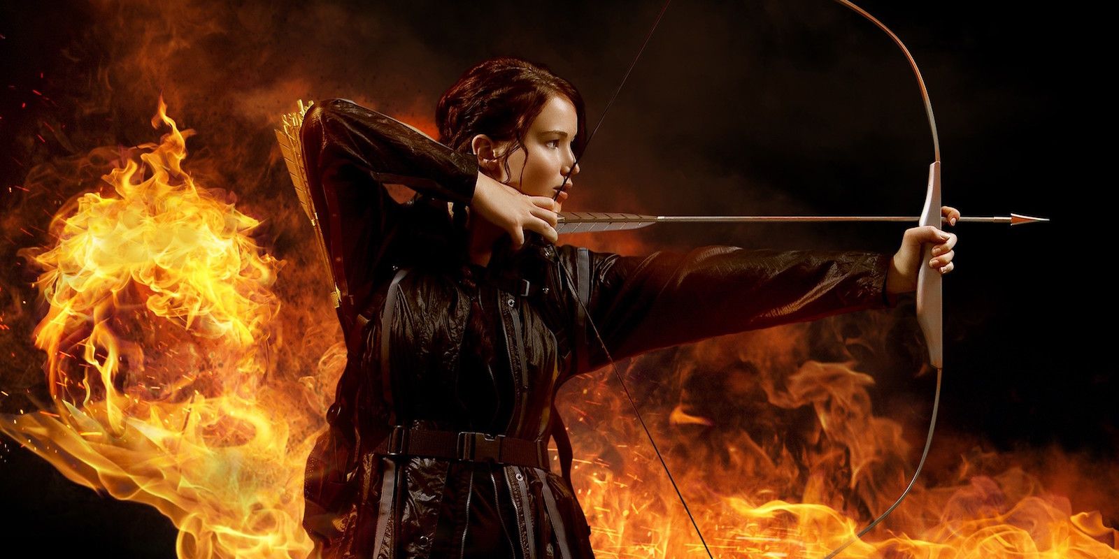 Katniss shooting an arrow with flames in the background from The Hunger Games