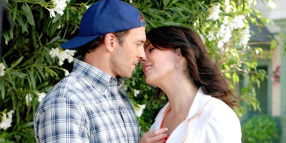 Luke and Lorelai on Gilmore Girls kiss and smile.