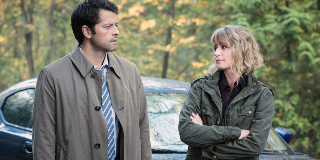 Supernatural's Mary and Castiel looking at each other in front of a car