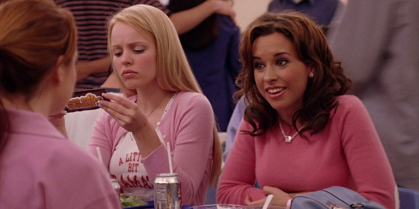 Cady sitting at the lunch table with Regina and Gretchen all wearing pink outfits in Mean Girls