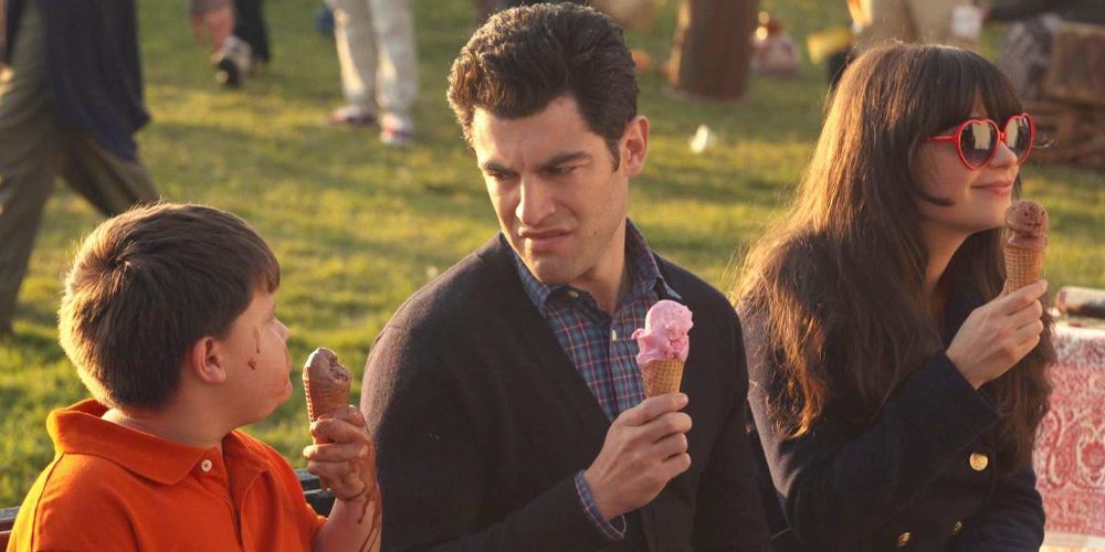 Schmidt holding an ice cream and making a face of disgust to a kid in New Girl