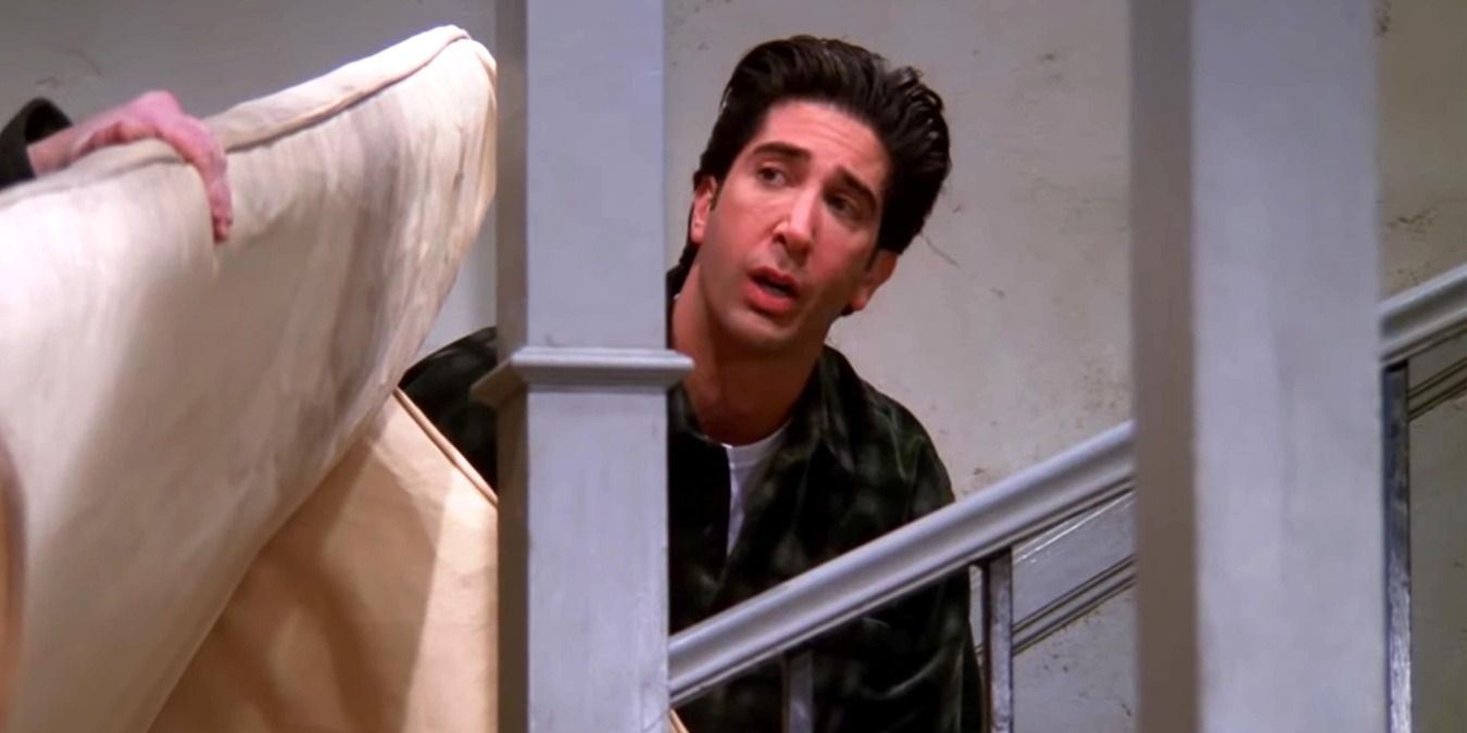 Ross carrying a couch up the stairs in Friends
