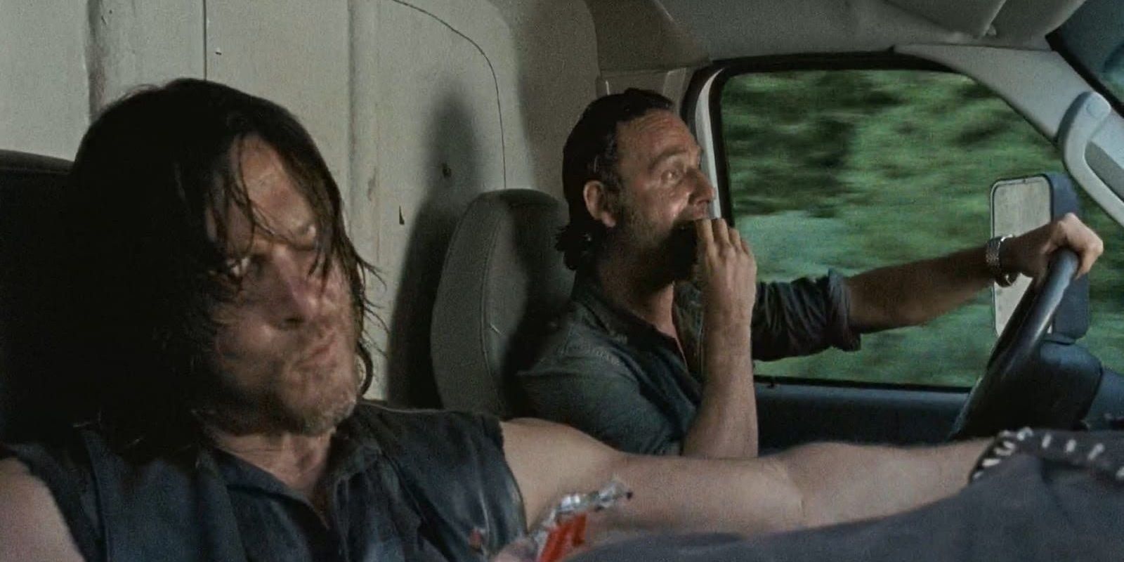 Rick and Daryl in a car eating chocolate